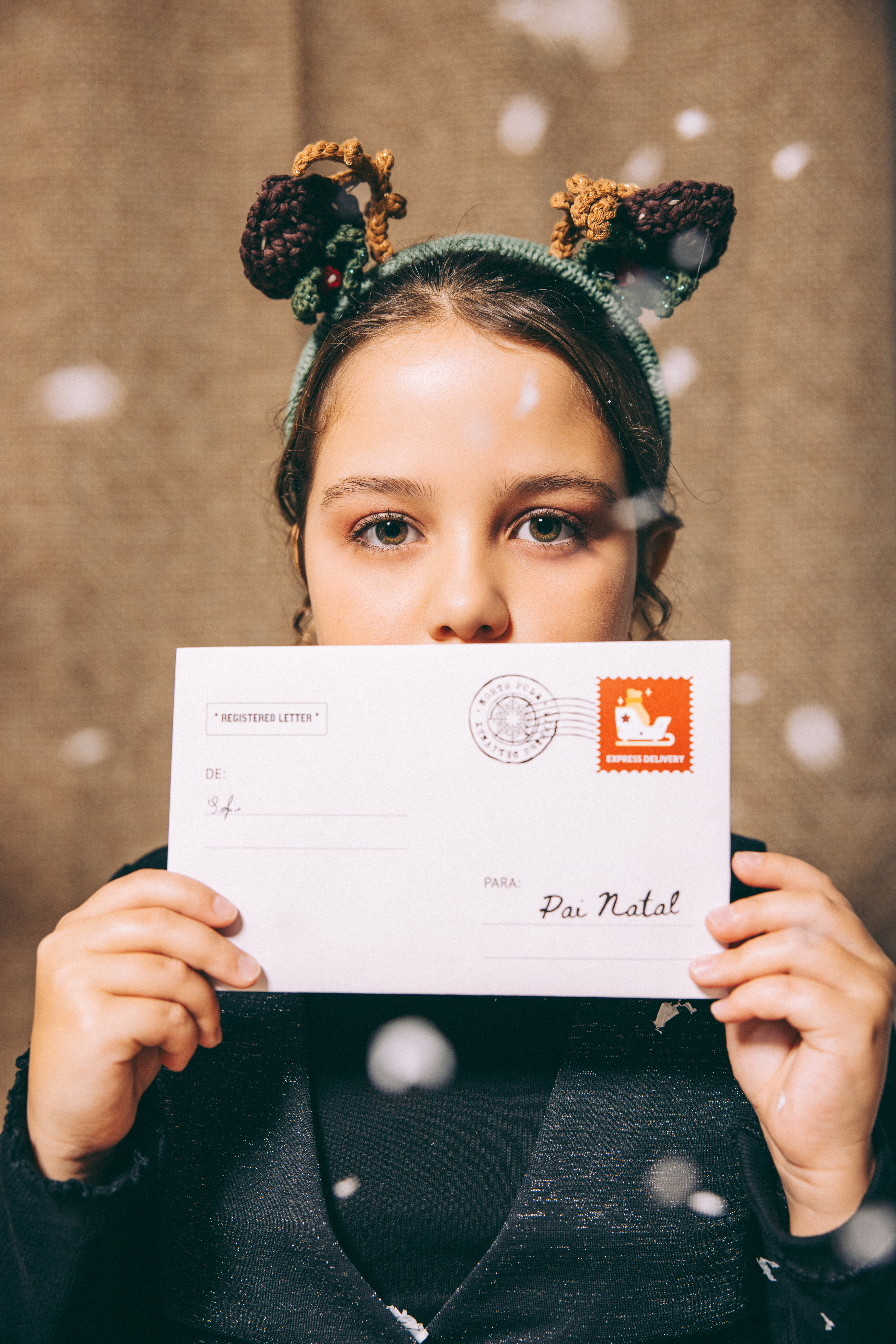 A kid holding a letter to santa